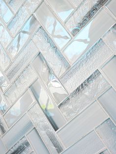 a close up view of some glass tiles on the wall in a room with blue and white colors