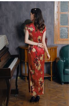 This striking Qipao aka Cheongsam is made from luxurious red silk, featuring intricate magnolia flower, mandarin collar and cap sleevee The red base, symbolic of joy and celebration, is complemented by delicate gold piping along the edges. Adorned with traditional knot buttons, this Qipao is ideal for weddings, banquets, or festive occasions, blending timeless Chinese fashion with modern refinement. Material: 90% Mulberry Silk, 10% Spandex Size Guide: Please note Asian size runs small, please ch Red Cheongsam For Spring Festivals, Red Cheongsam For Spring Festive Occasion, Traditional Red Cheongsam For Formal Occasions, Festive Red Cheongsam For Spring, Fitted Cheongsam For Festivals, Red Fitted Cheongsam For Festive Occasions, Fitted Red Cheongsam For Festive Occasions, Festive Red Fitted Cheongsam, Festive Fitted Red Cheongsam