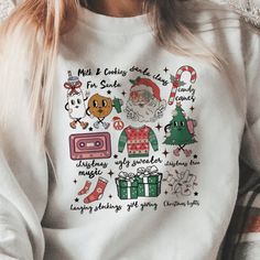 Wrap yourself in the spirit of the season with our 'Retro Christmas Cheer Icon Sweatshirt'. Each sweatshirt, crafted by our small business, features a playful array of holiday icons, from Santa and candy canes to cozy sweaters and gift-giving delights. Perfect for holiday parties or just spreading cheer, our sweatshirt is available in a selection of colors and sizes. Dive into the holiday festivities with this must-have piece by visiting our website and choosing your favorite today! Please choos Holiday Graphic Print Sweater, Holiday Cotton Sweater With Graphic Print, Casual Graphic Print Holiday Sweatshirt, Casual Graphic Print Sweatshirt For Holiday, Casual Holiday Sweatshirt With Graphic Print, Holiday White Graphic Print Sweatshirt, Holiday Graphic Print White Sweatshirt, Casual Holiday Sweater With Graphic Print, Christmas Graphic Print Holiday Sweatshirt