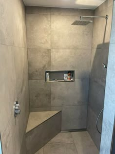 a walk in shower sitting inside of a bathroom