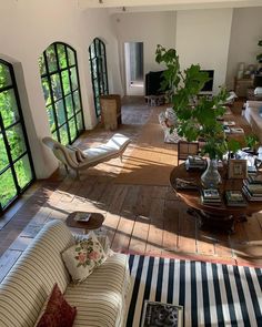 a living room filled with furniture and lots of windows