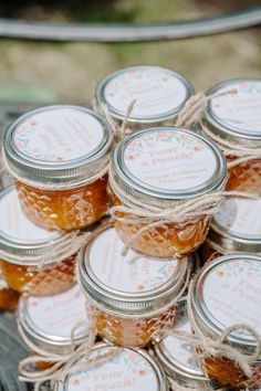 small jars filled with honey sitting on top of a table