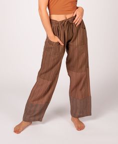 Our lightest weight beach pants! Whether you're just looking to kick back or you're out combing the beach for shells, these lightweight patchwork pants are just the right jam.  Made from a few different lightest weight, striped fabrics patched together, they have two front pockets, one back pocket, and a drawstring/elastic waist. A favorite of our patchwork clothing options at Soul Flower! Shades will vary as is the nature of patchwork. Wear these puttin' on the jams patchwork pants or any of ou Earthy Pants, Beachy Cotton Bottoms With Pockets, Brown Bottoms For Beach Season, Brown Beach Bottoms For Beach Season, Bohemian Style Brown Pants For Vacation, Bohemian Brown Pants For Vacation, Relaxed Fit Patchwork Bottoms For Summer, Brown Pants With Pockets For Vacation, Bohemian Loose Fit Bottoms For Beach Season