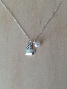 "Delicate. Beautiful. Elegantly Simple. Sterling Silver 9mm (0.35 inches) heart pendant necklace. This lovely heart pendant is accented by a small pearl or 6mm Swarovski crystal charm of your choice and hangs delicately from a Sterling Silver chain. Shown in 16\" length with a pearl accent. Please message me if you would like more than the quantity listed. I can produce custom orders of any quantity within a week. Visit my shop: http://www.etsy.com/shop/Jadedslo All items are handmade and I guar Gold Moon Necklace, Sterling Silver Heart Necklace, Necklace Birthstone, Gold Heart Necklace, Gold Moon, Silver Heart Necklace, Solid Gold Jewelry, Crystal Charm, Moon Necklace