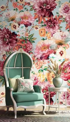 a room with flowers on the wall and a blue chair in front of it,