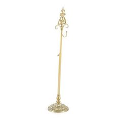 a gold colored metal umbrella stand on a white background