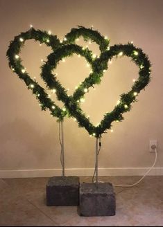 two heart shaped trees with lights on them