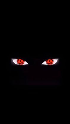 the eyes of an evil looking person in the dark with red light coming from them