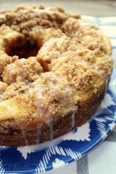 a close up of a doughnut on a plate with icing and crumbs