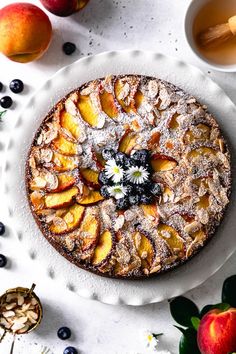 a cake on a plate next to some fruit