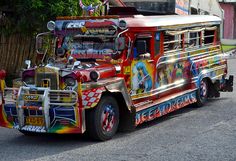 a colorful bus is parked on the side of the road