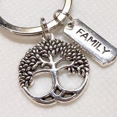 a keychain with a tree on it that says family