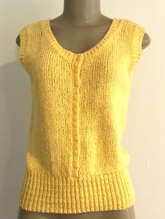 "Vintage 1980s Renee Tener For Jeanne Pierre yellow knit sleeveless sweater or vest, featuring a button front and all around neck, arm openings and waistband in contrasting knit stitch. Approximate Measurements: Chest: 36\" - 40\"; Waistband: 22\" - 30\"; Length: 22\" (Stretch to fabric accommodates range) Labeled a size Small Fabric: 55% ramie, 45% cotton Condition: Jeanne Pierre yellow sweater / vest, circa 1980s, is in excellent vintage condition, with no indication it was ever even worn. Enj Sleeveless Knit Sweater Vest With Buttons, Vintage Sleeveless Tank Top For Fall, Vintage Sleeveless Winter Tops, Vintage Sleeveless Tops For Winter, Vintage Knit V-neck Sweater Vest, Retro Sleeveless Knit Sweater, Retro Fitted Sleeveless Sweater, Vintage Sleeveless Sweater Vest With Buttons, Fitted Retro Knit Sweater Vest