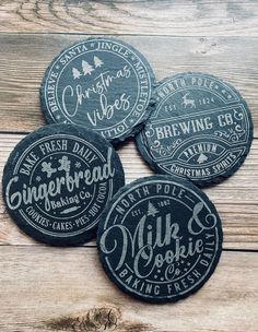 four black coasters with white lettering on them