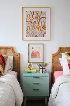 two twin beds with colorful pillows and blankets