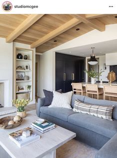 a living room filled with furniture and a fire place in front of a dining table