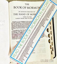 the book of mormon is laying on top of an open book