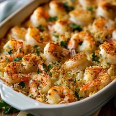 a casserole dish with shrimp and bread crumbs