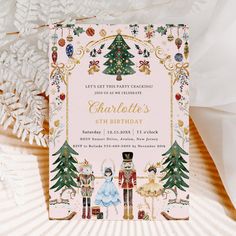 a pink and gold christmas card with an image of the nutcrackers on it