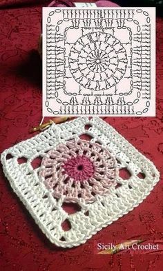 a crochet granny is laying on a red table