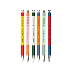 four pens with different colored writing on them