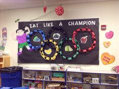 a classroom wall decorated with colorful paper bracelets