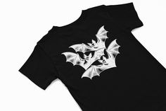 Inverted Vampire bat design t shirt  Vintage Halloween T Shirt Halloween Graphic Tee Spooky Season Shirt Halloween Aesthetic Tee Gothic Halloween Shirt Halloween Ghost Shirt Halloween Party TShirt Cute Halloween Designs Retro Halloween Apparel Funny Halloween Costume Shirt Witchy Vibes TShirt Halloween 2024 TShirt A classic unisex t-shirt that works well with any outfit. Made of a heavier cotton with a double-stitched neckline and sleeves. *Rolled-forward shoulders for a better fit *Stylish fitt White Gothic T-shirt For Streetwear, Edgy Halloween Graphic Tops, Halloween T-shirt With Back Print And Crew Neck, Halloween Black Tops With Back Print, Halloween Crew Neck Top With Back Print, Black Halloween Tops With Back Print, Gothic White T-shirt For Streetwear, Edgy Halloween T-shirt With Sublimation Print, Halloween Graphic Tee Shirt With Graphic Design