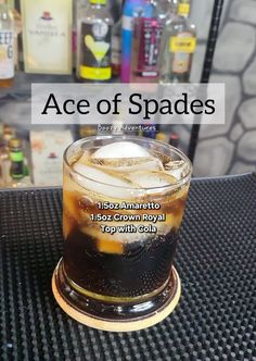 a glass with ice and soda sitting on top of a table