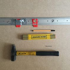 tools are laid out on the floor next to a ruler and pencils with holes in them