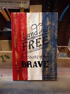 a wooden sign that says land of free because of brave