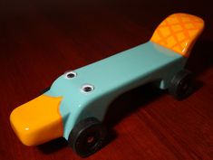 a wooden toy car sitting on top of a table