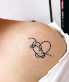 a woman with a tattoo on her shoulder and the word love written in black ink