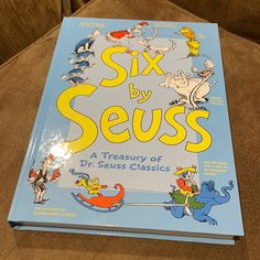 there is a book on the couch that says six by seuss, with pictures of dr seuss