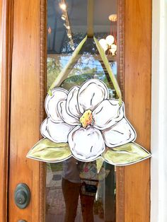 a door with a flower cut out of the glass and hanging on it's side