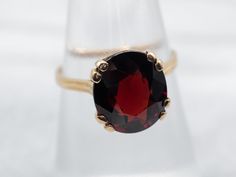 This beautiful yellow gold solitaire ring showcases a single garnet gemstone. Its timeless design and quality craftsmanship lasts for generations, providing you with a timeless piece of jewelry for decades to come.Metal: 18K Yellow GoldGem: Garnet 5.11 CaratsGem Measurements: 9.9 x 11.3 mm, OvalRing Size: 6.50 Classic Garnet Round Cut Ring, Classic Garnet Rings With Round Cut, Classic Garnet Ring With Round Cut, Classic Yellow Gold Garnet Birthstone Ring, Classic Garnet Birthstone Ring In Yellow Gold, Formal Garnet Birthstone Ring In Fine Jewelry Style, Formal Garnet Birthstone Ring Fine Jewelry, Formal Garnet Birthstone Ring, Classic Rings With Garnet And Prong Setting