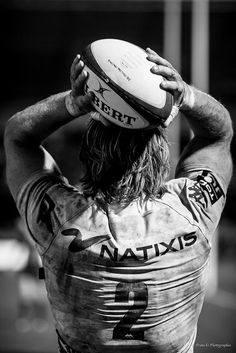 a man with a rugby ball on his head