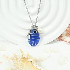 a necklace with a blue egg and pearls on it