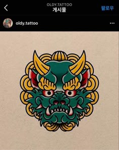 an old tattoo sticker with a dragon head on it's face and two horns