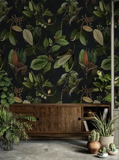 the wallpaper in this room is very dark and has green leaves on it, as well as some potted plants