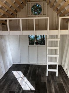 there is a ladder in the corner of this room that leads to a loft bed