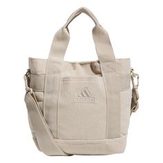 the adidas canvas tote bag is beige and has two zippers on each side