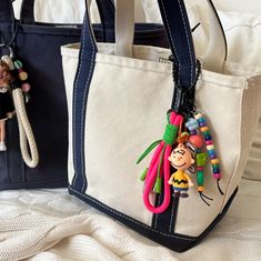 two purses are decorated with colorful beaded charms and beads hanging from the handles