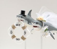 two wedding cake toppers with sharks on them