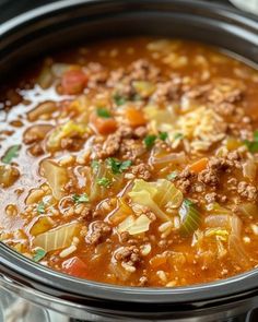 a crock pot filled with meat and vegetables