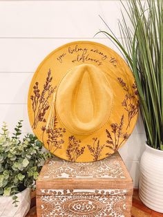 Wildflower Burned Hat, Floral Engraved Cowboy Hat, Sunflower Hat, Sunflower Burned Fedora, Engraved Suede Hat, Boho Hat, Vegan Suede Elevate your style with our beautifully engraved floral hats! Choose from a variety of different hat colors. Band may shift or fall off during shipping. The hat has an adjustable band on the inside to fit many sizes. One size fits most adult heads. If you are looking for a custom order, please message us! Bride Cowgirl Hat With Aunflowers, Cow Print Burned Hat, Yellow Bohemian Fedora Hat, Bohemian Yellow Brimmed Hat, Yellow Bohemian Hat With Flat Brim, Yellow Bohemian Brimmed Hat, Hat Burning Patterns, Burning Hats, Cowboy Hat Crafts