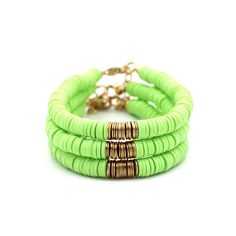 A lime green heishi bead bracelet is the perfect on-trend accessory to top off your look. It is a great stand alone bracelet and works well as a stack bracelet, too. This non-stretch bracelet features lime green polymer clay heishi beads with gold brushed metal beads in the center, all hand-strung onto flexible jewelry wire. The bracelet is finished off with a lobster clasp, and a 1" extender chain to accommodate various wrist sizes. MATERIALS Polymer Clay & Metal Beads SIZE 6 1/2" Extendable Up Green Heishi Beads Jewelry For Beach, Green Heishi Beads Bracelets For Summer, Trendy Green Stretch Bracelet Stackable, Trendy Green Stackable Stretch Bracelet, Green Heishi Beads Bracelets For Beach, Green Bracelets For Beach Spring Season, Green Bracelets For Beach In Spring, Green Heishi Beads Summer Jewelry, Green Stackable Stretch Bracelet For Beach