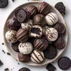 a bowl filled with chocolate covered cookies and oreos