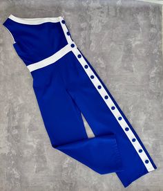 Royal blue and white pageant jumpsuit with buttons/ Interview romper/ Girls pants outfit/ Pageant interview wear/ Custom pageant outfit This beautiful jumpsuit is made out of polyester fabric. This material is stretchy. The jumpsuit has zipper back. It is easy to care and comfortable to wear. It is decorated with buttons. It looks amazing. The jumpsuit is perfect for interview wear and other pageant events. It is absolutely stunning on!  Materials Polyester fabric  Colors and sizes The jumpsuit can be made in any color and size.  Message me and I'll happily send you a color chart. Offer more than 30 different colors to choose from.  All items are made to order.  Jumpsuit is tailored to order in any standard size.  The size chart is the picture of the listing. If you want it to fit perfectl Fitted White Jumpsuits And Rompers With Buttons, White Fitted Jumpsuits And Rompers With Buttons, Girls Pants Outfit, Pageant Jumpsuit, Pageant Casual Wear, Pageant Interview, Pageant Outfits, Beautiful Jumpsuits, Girls Rompers