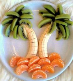 a white plate topped with sliced oranges and banana's on top of each other