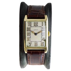 FACTORY / HOUSE: Gruen Watch Company STYLE / REFERENCE: Art Deco / Tank Style METAL / MATERIAL: 14Kt. Solid Gold CIRCA / YEAR: 1930 DIMENSIONS / SIZE: Length 37mm X Width 23mm MOVEMENT / CALIBER: Manual Winding / 17 Jewels / Caliber 98 DIAL / HANDS: Original Silvered Dial with Luminous Arabic Markers / Blued Steel Luminous Hands ATTACHMENT / LENGTH: Leather, 17mm / Regular Length WARRANTY: 18 months on the movement This is a "vault find" watch, it has been locked up for nearly 50 years, which me Gruen Watches, Factory House, 1930 Art, Reference Art, Style Reference, Vintage Stockings, Style Watch, Watch Companies, Metal Material